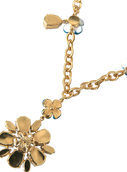 a close up of a necklace with flowers on it