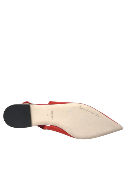 a woman's red and white shoe with a black sole