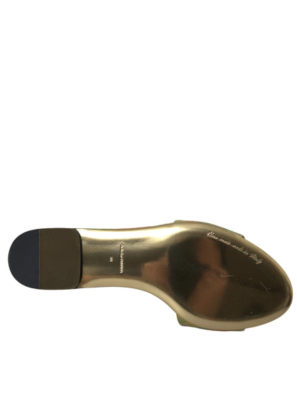 a close up of a gold shoe on a white background