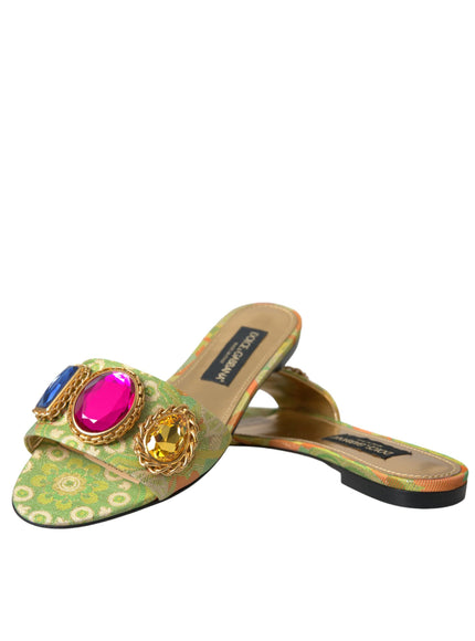 a pair of green shoes with a pink jewel