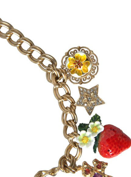 a gold bracelet with a strawberry, flower, and star charms