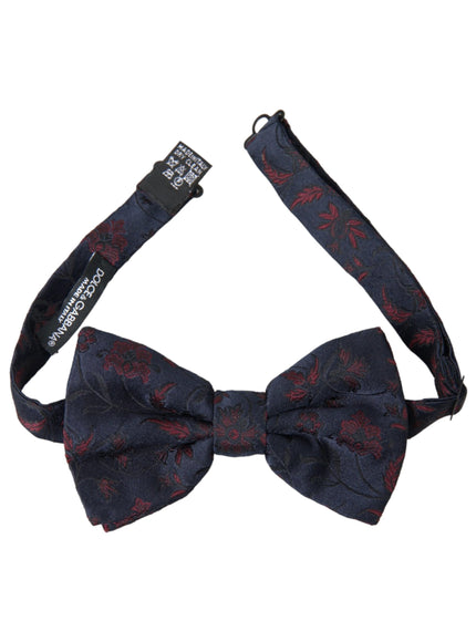 a blue bow tie with red flowers on it