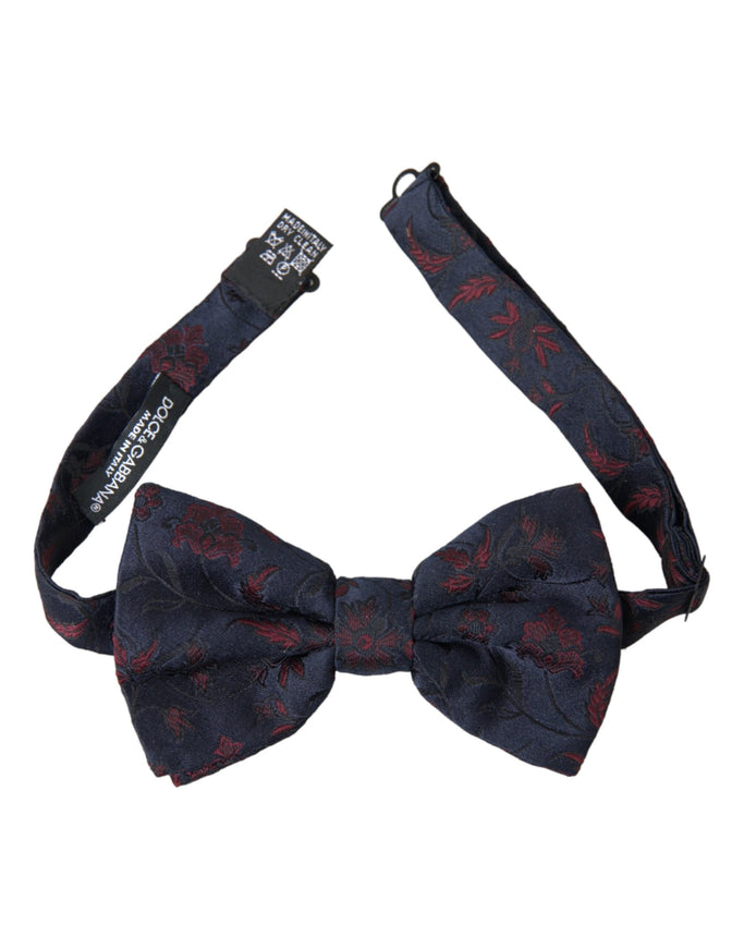 a blue bow tie with red flowers on it