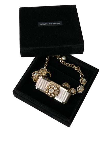 a black box with a gold chain and a white bow