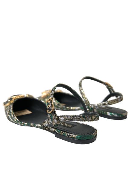 a pair of black sandals with a gold chain