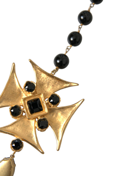 a black and gold necklace with a cross on it