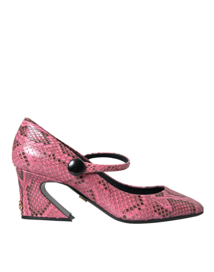 a pair of pink snakeskind shoes with a black heel