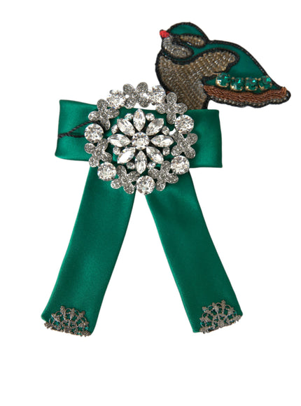 a green ribbon with a brooch on top of it