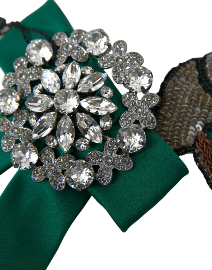 a close up of a brooch on a green ribbon