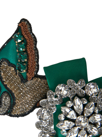 a green brooch with a bird on it