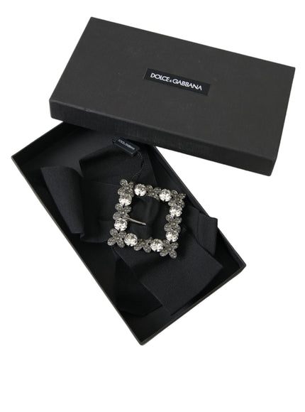 a black box with a tie and a brooch in it