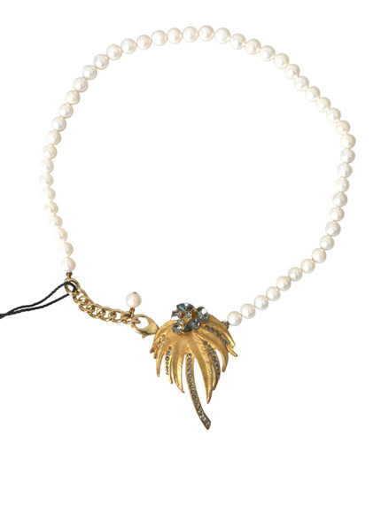 a pearl necklace with a gold leaf charm