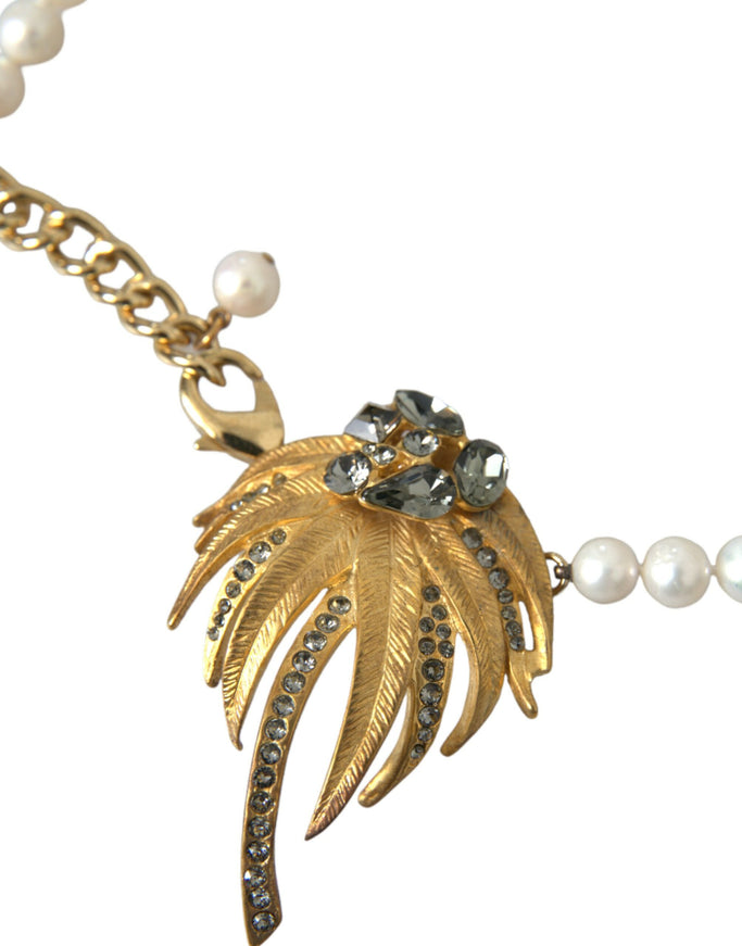 a necklace with a leaf and pearls on it