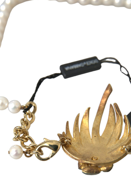 a gold bracelet with pearls and a black cord