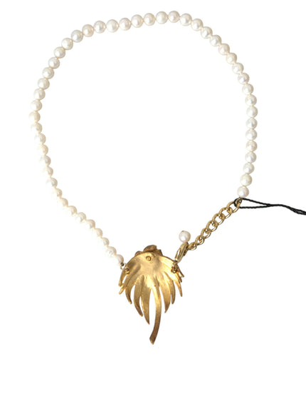 a pearl necklace with a gold leaf charm