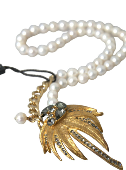 a necklace with pearls and a leaf charm