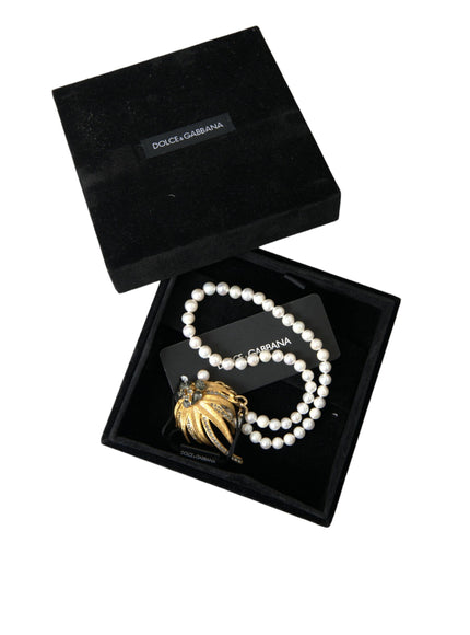 a necklace in a black box with a gold leaf charm