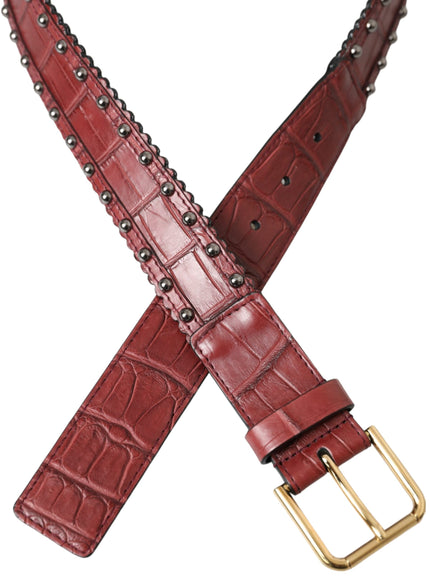 a red alligator skin belt with a gold buckle