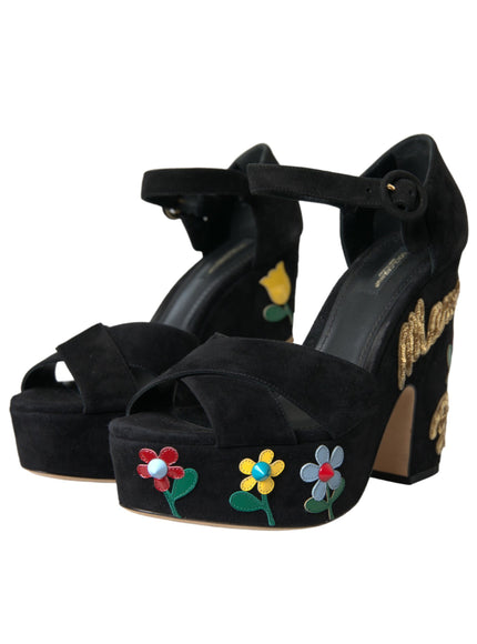 a pair of black high heels with flowers on them