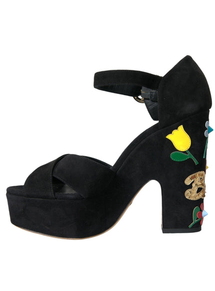 a black high heeled shoe with a yellow rose on it