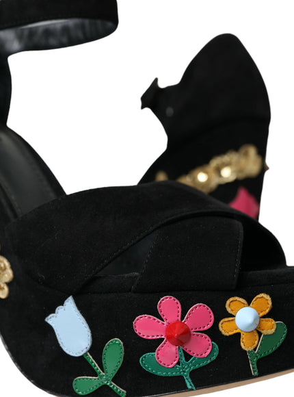 a pair of black shoes with flowers on them