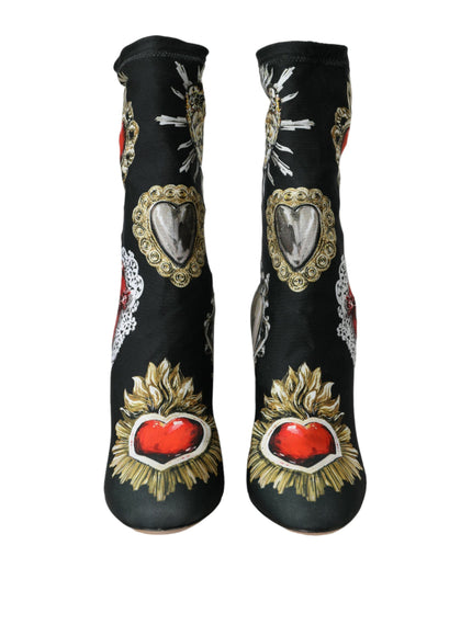 a pair of black boots with a red heart on it