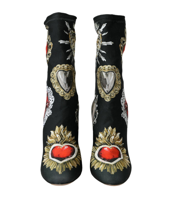 a pair of black boots with a red heart on it