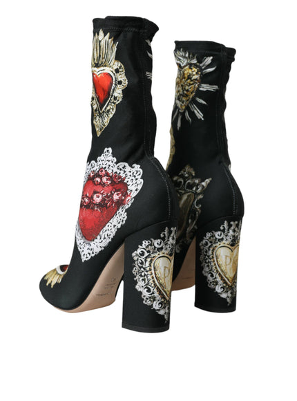 a pair of black high heeled shoes with hearts on them