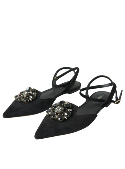 a pair of black shoes with a jewel buckle