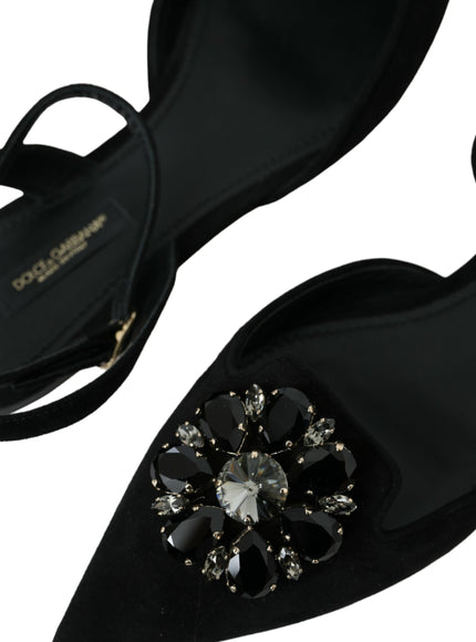 a pair of black shoes with a jeweled shoe clip