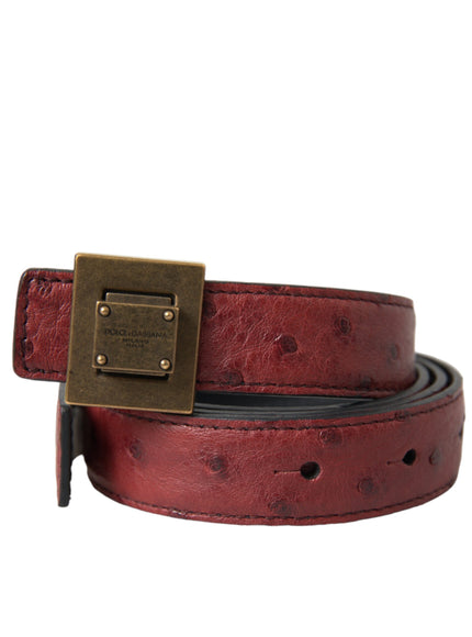 a red belt with a gold buckle on it