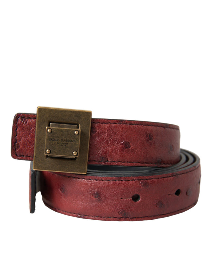 a red belt with a gold buckle on it