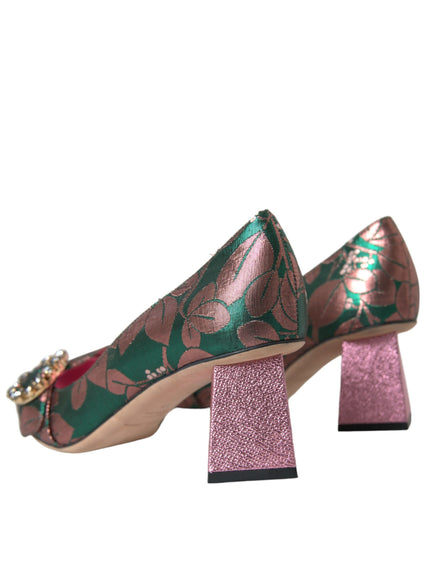 a pair of pink and green shoes on a stand