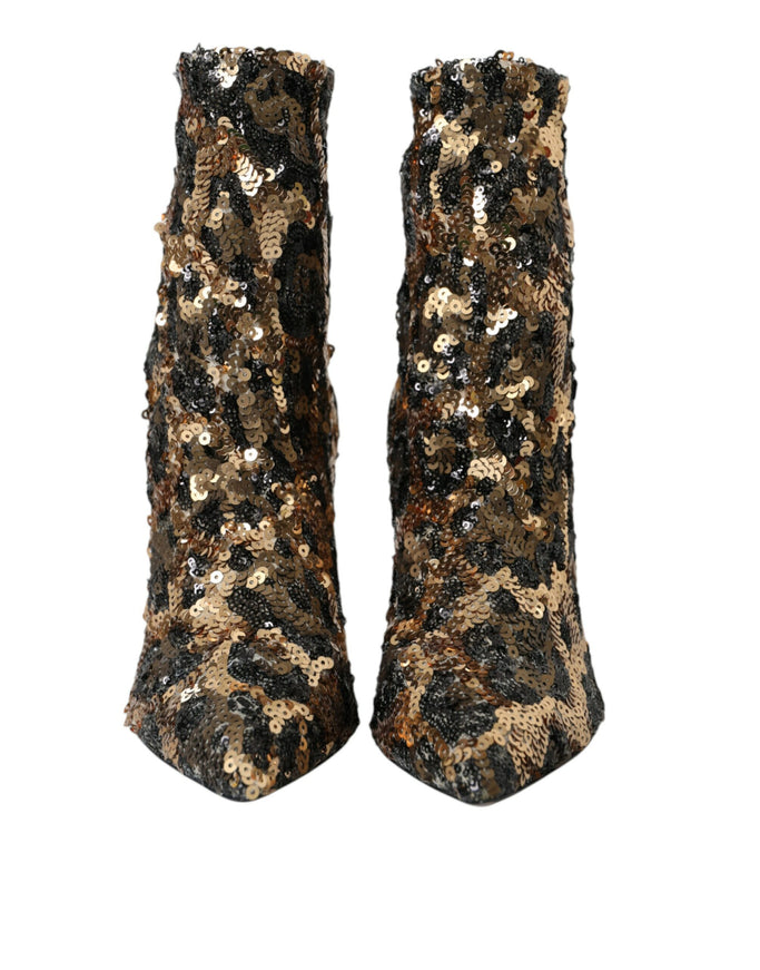 a pair of black and gold sequin boots