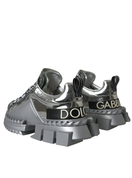 a pair of silver sneakers with black lettering