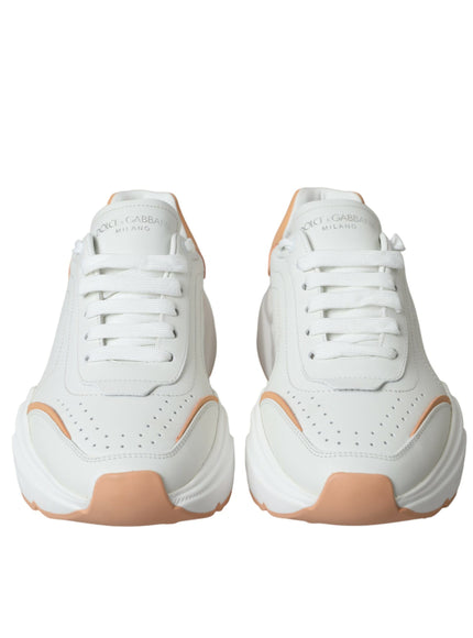 a pair of white and orange sneakers