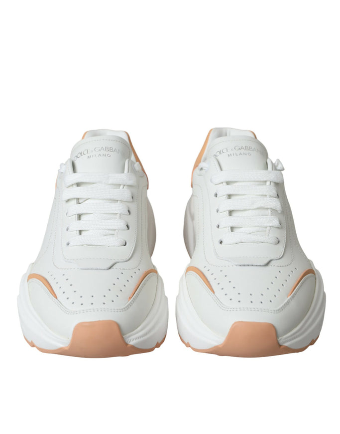 a pair of white and orange sneakers