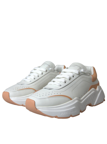 a pair of white and orange sneakers