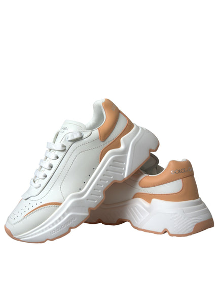 a pair of white and orange sneakers