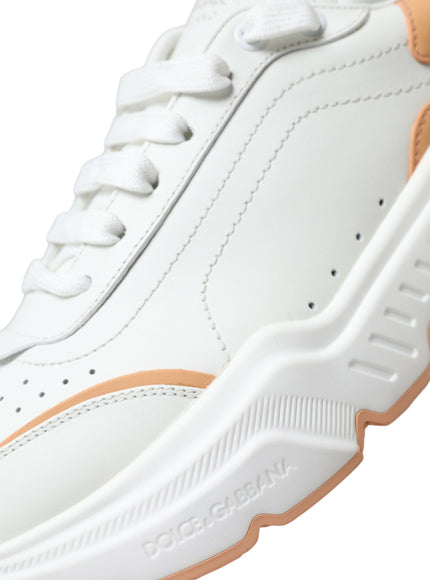 a pair of white and orange sneakers on a white background