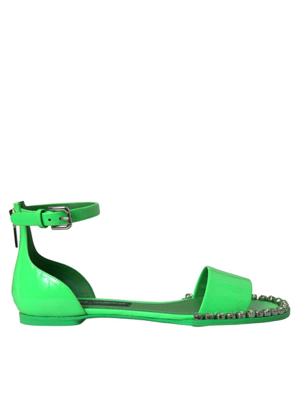 a pair of green shoes with studded straps