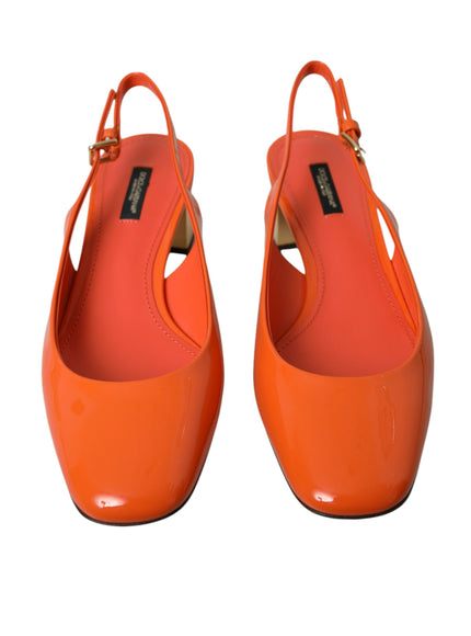 a pair of orange high heels on a white background