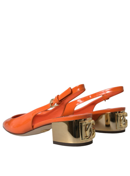 a pair of orange shoes with a gold heel