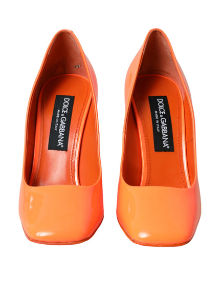 a pair of orange high heels on a white background