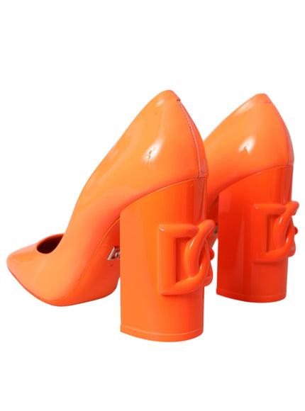 a pair of orange high heeled shoes on a white background