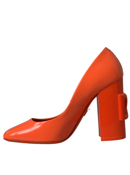 a pair of orange high heeled shoes on a white background