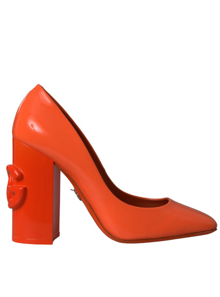 a pair of orange high heels with a bow on the heel