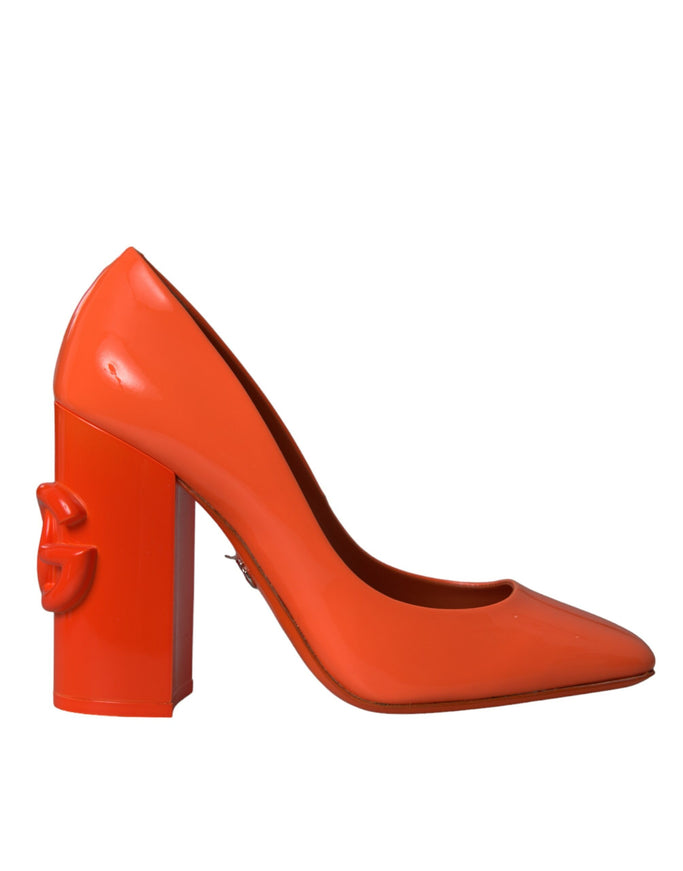 a pair of orange high heels with a bow on the heel