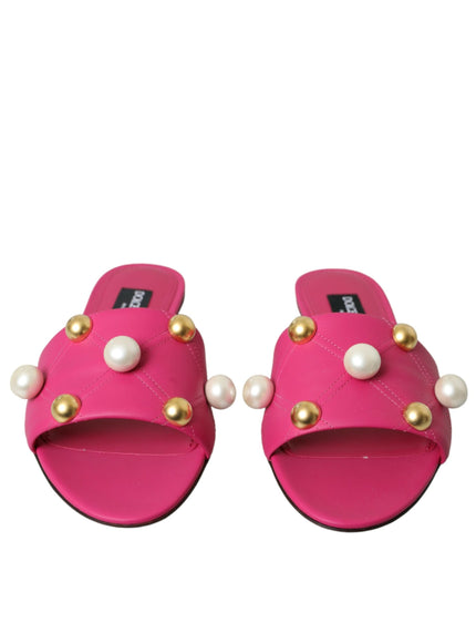 a pair of pink sandals with pearls on them