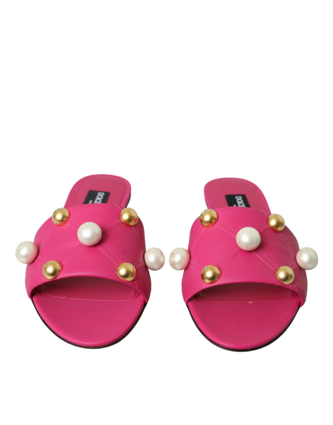 a pair of pink sandals with pearls on them